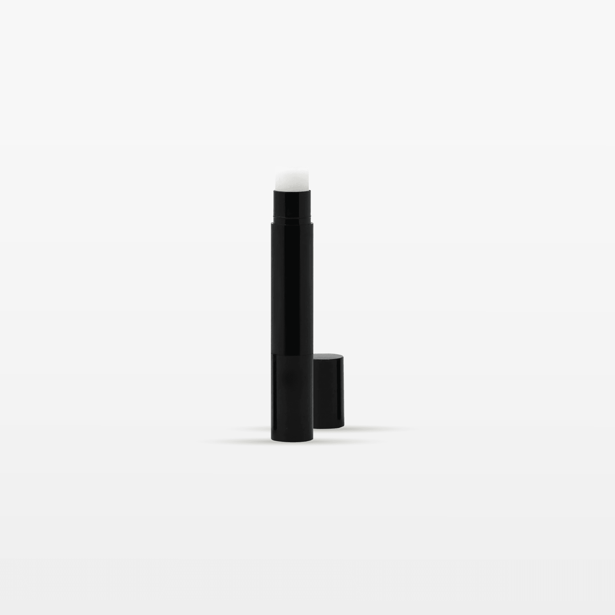 THE LIP BALM in a sleek black tube for easy hydration and comfort for dry lips.