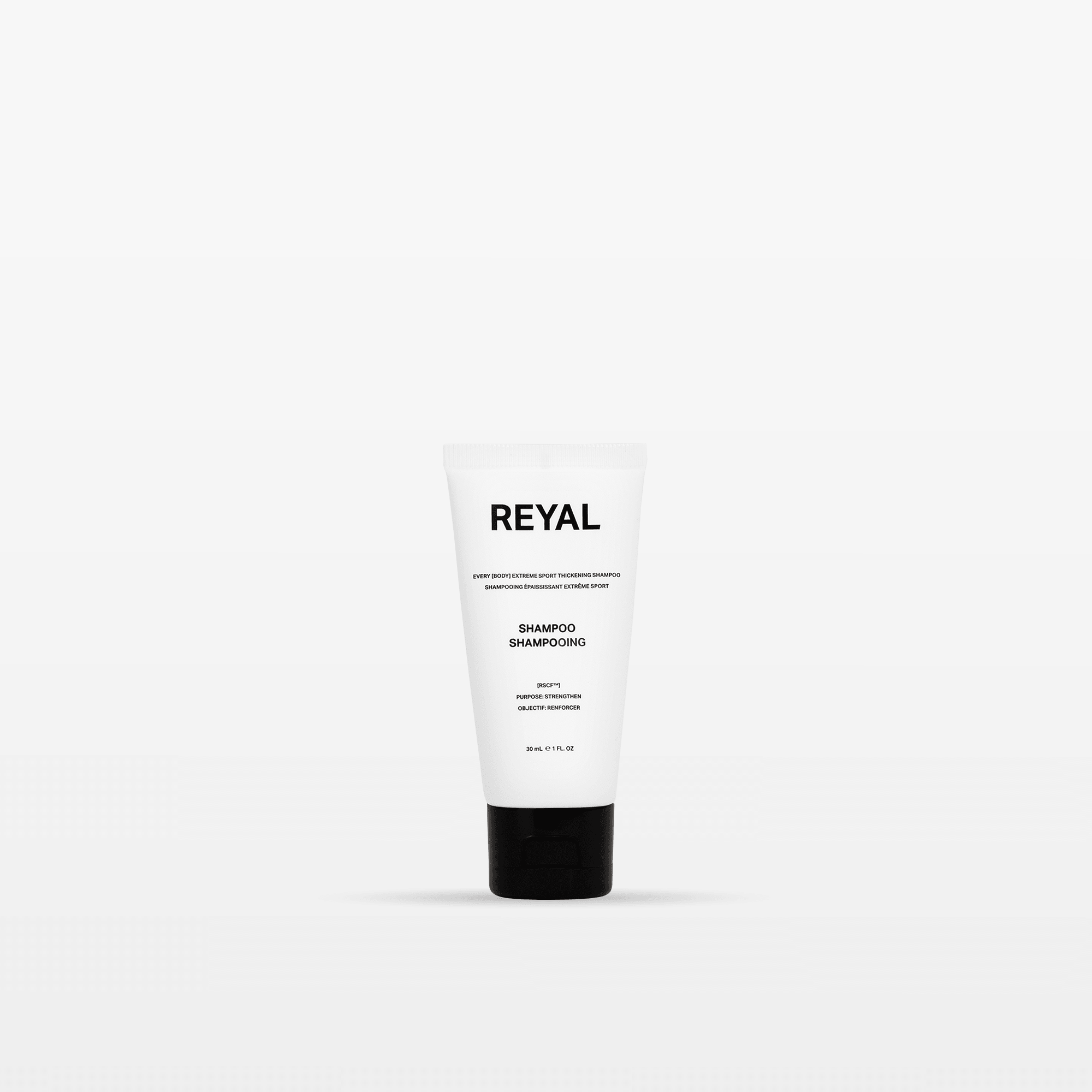 THICKENING SHAMPOO [TRAVEL] product image in a sleek white tube with black cap.
